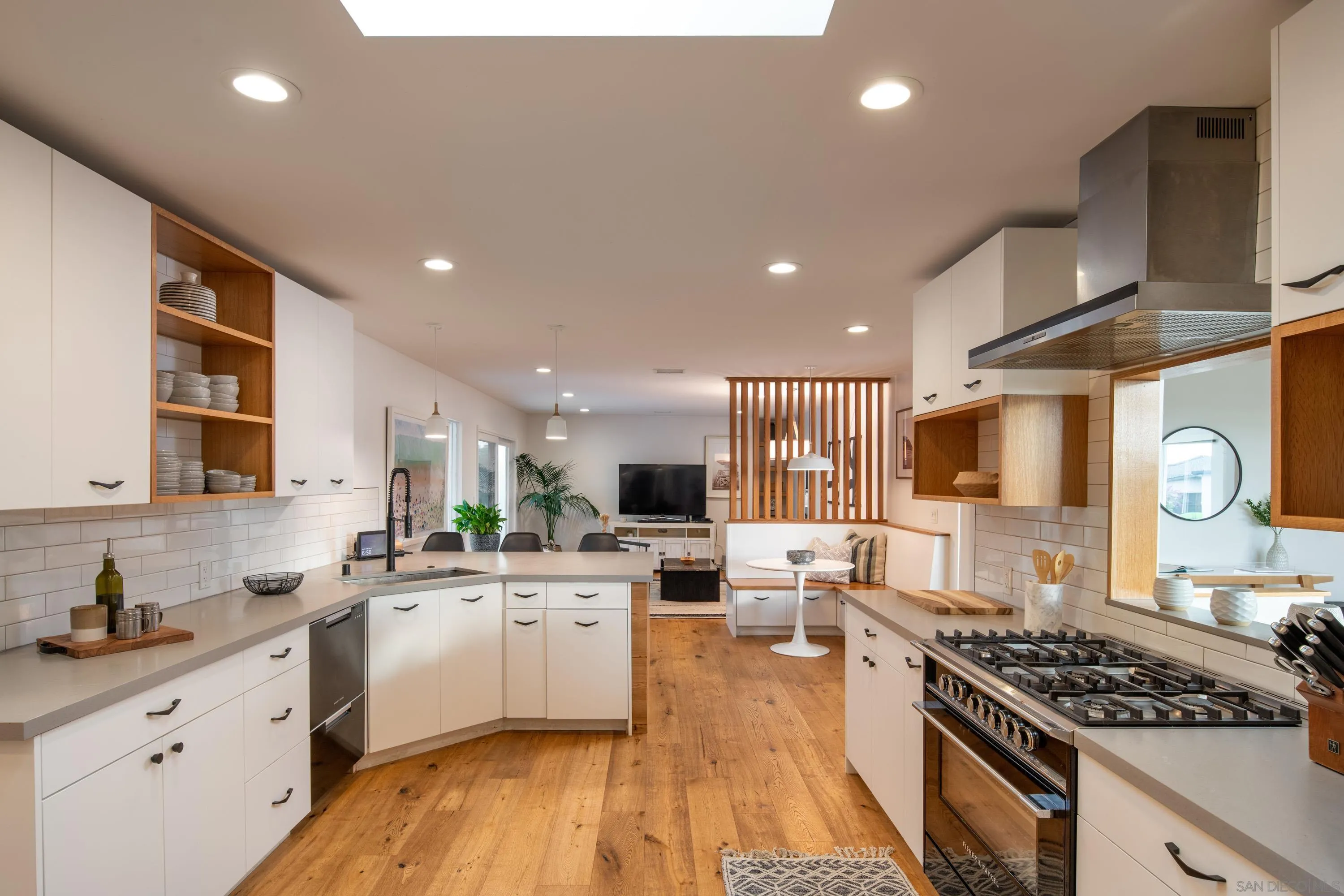 6529 Manana Place La Jolla, CA 92037 - Photo 15 of 36 a kitchen with stainless steel appliances a sink a stove top oven a counter space and cabinets