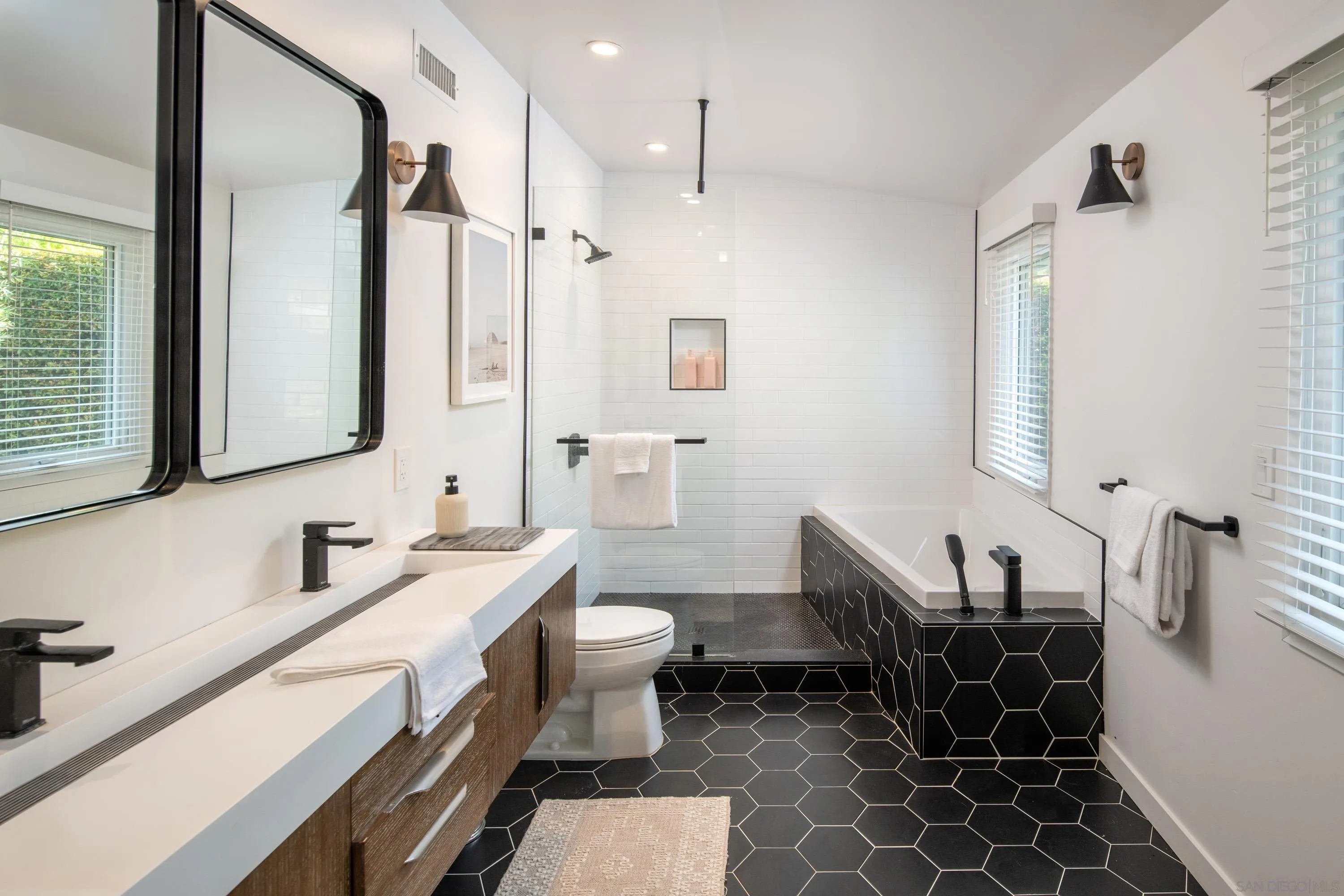 6529 Manana Place La Jolla, CA 92037 - Photo 19 of 36 a bathroom with a sink and a mirror
