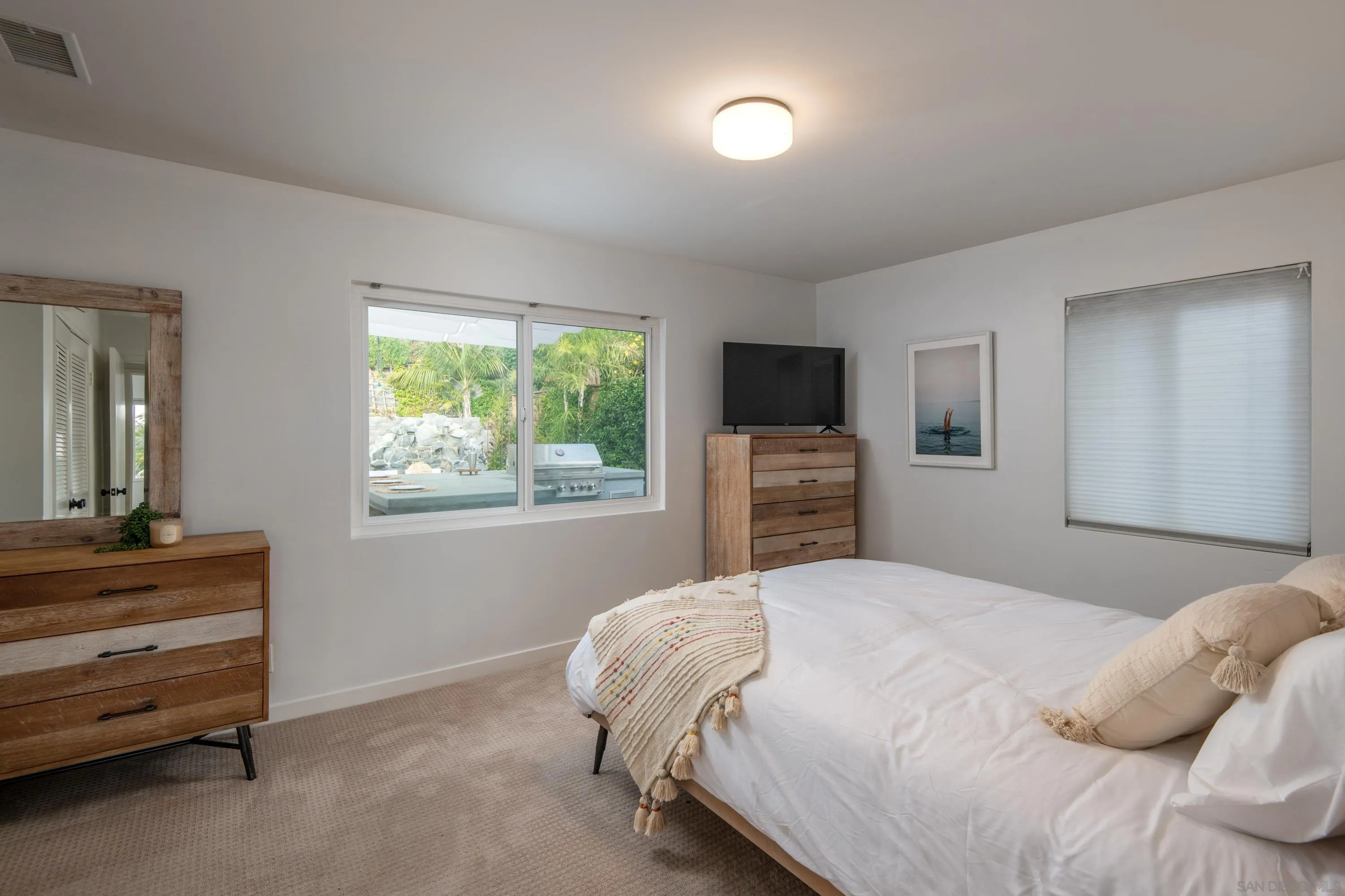 6529 Manana Place La Jolla, CA 92037 - Photo 20 of 36 a bedroom with a bed and a television