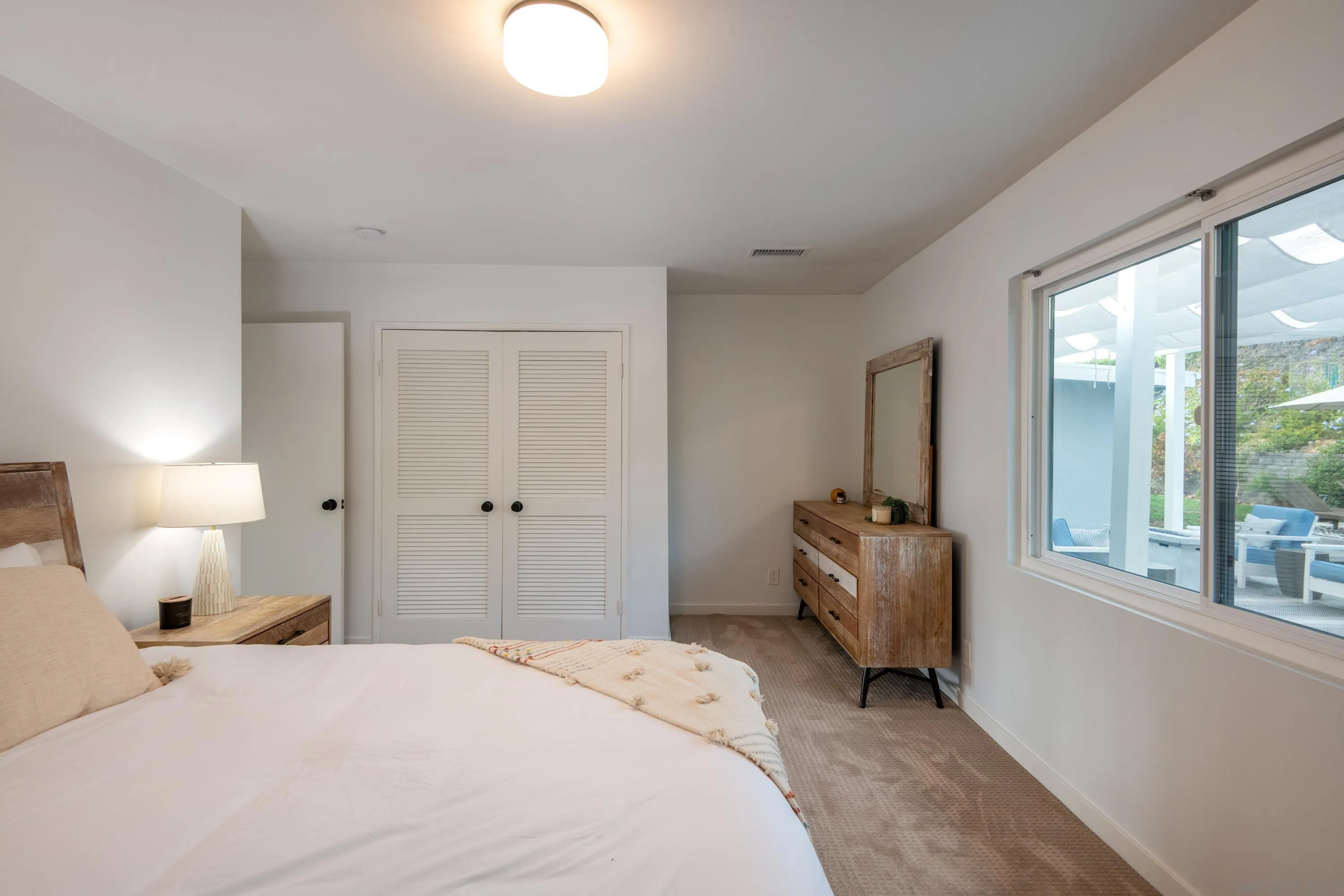6529 Manana Place La Jolla, CA 92037 - Photo 22 of 36 a bedroom with a bed and a large window
