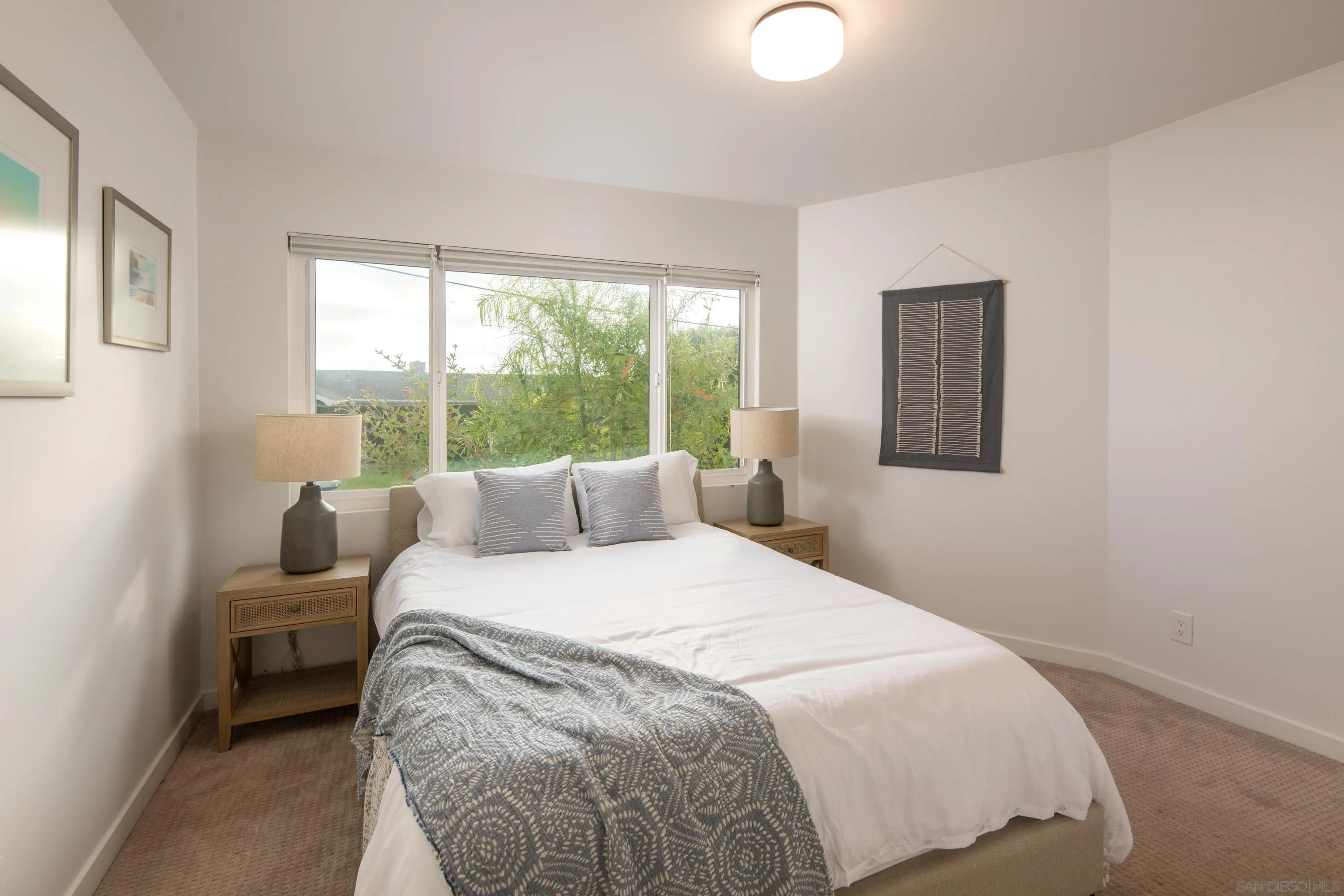 6529 Manana Place La Jolla, CA 92037 - Photo 24 of 36 a bedroom with a bed and a lamp