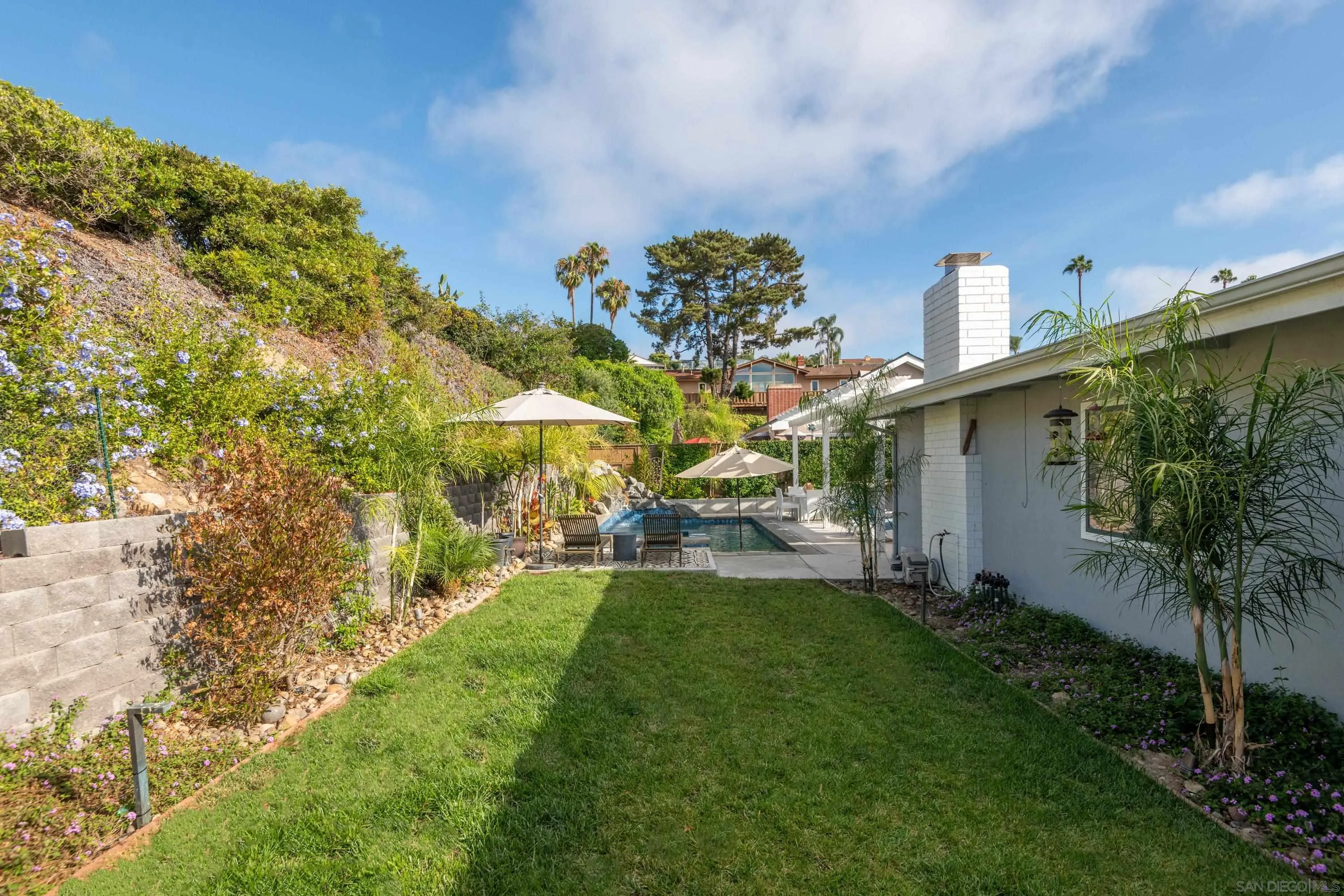 6529 Manana Place La Jolla, CA 92037 - Photo 31 of 36 a view of a house with a big yard potted plants and a large tree