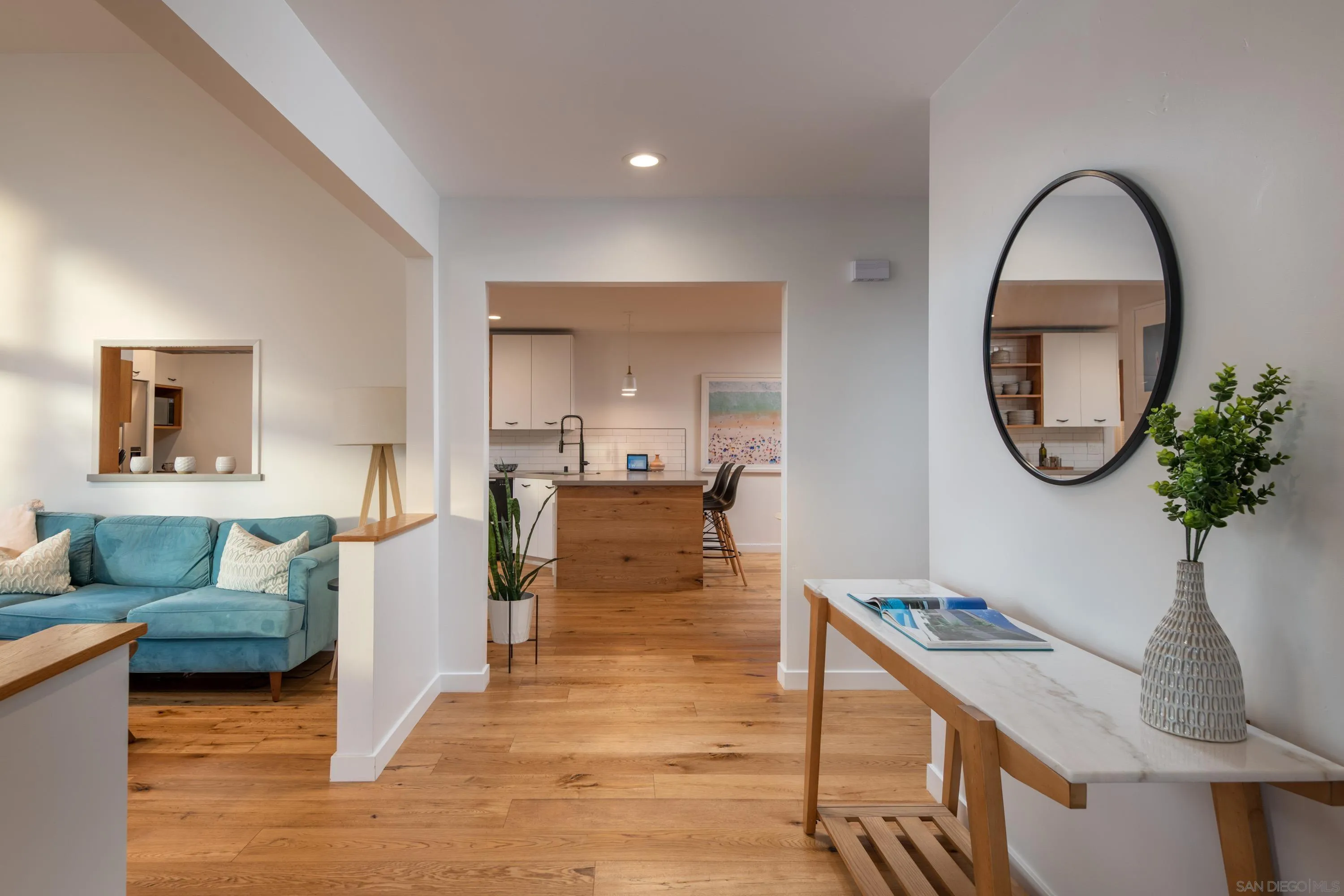 6529 Manana Place La Jolla, CA 92037 - Photo 6 of 36 a living room with furniture a mirror and a potted plant