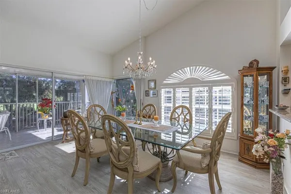 a view of a dining room with furniture wooden floor and chandelier
