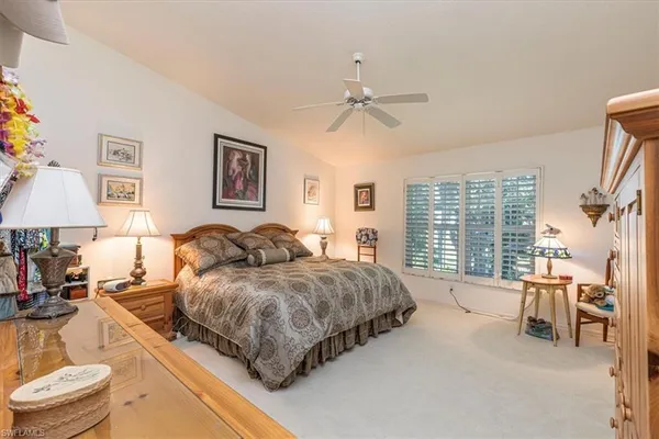 a living room with a bed furniture and a large window