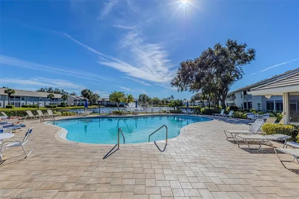 a view of swimming pool with outdoor seating and plants