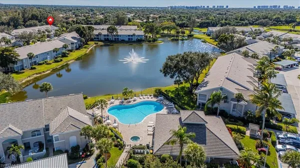 an aerial view of residential houses with outdoor space and river view