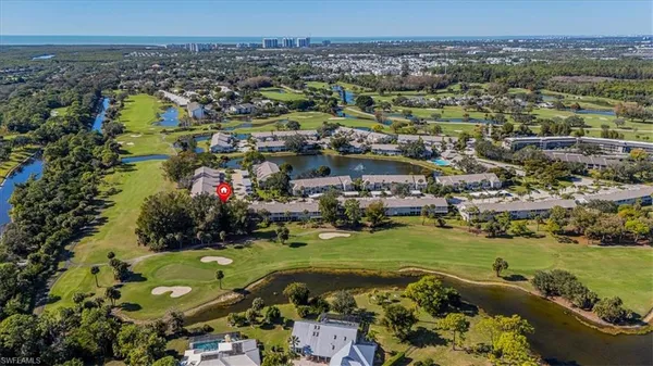 an aerial view of a houses with a lake view