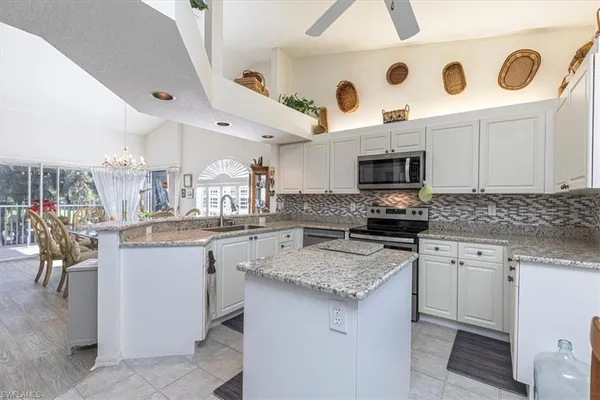 a kitchen with a sink a stove and cabinets