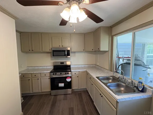 a kitchen with stainless steel appliances granite countertop a sink and a stove