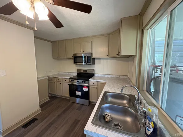 a kitchen with a appliances a sink and cabinets