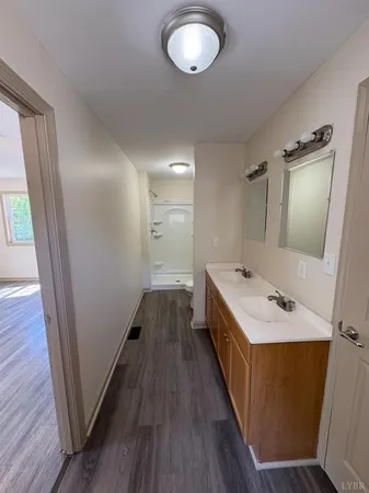 a bathroom with 2 sink and a mirror