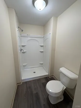 a bathroom with a toilet and a shower