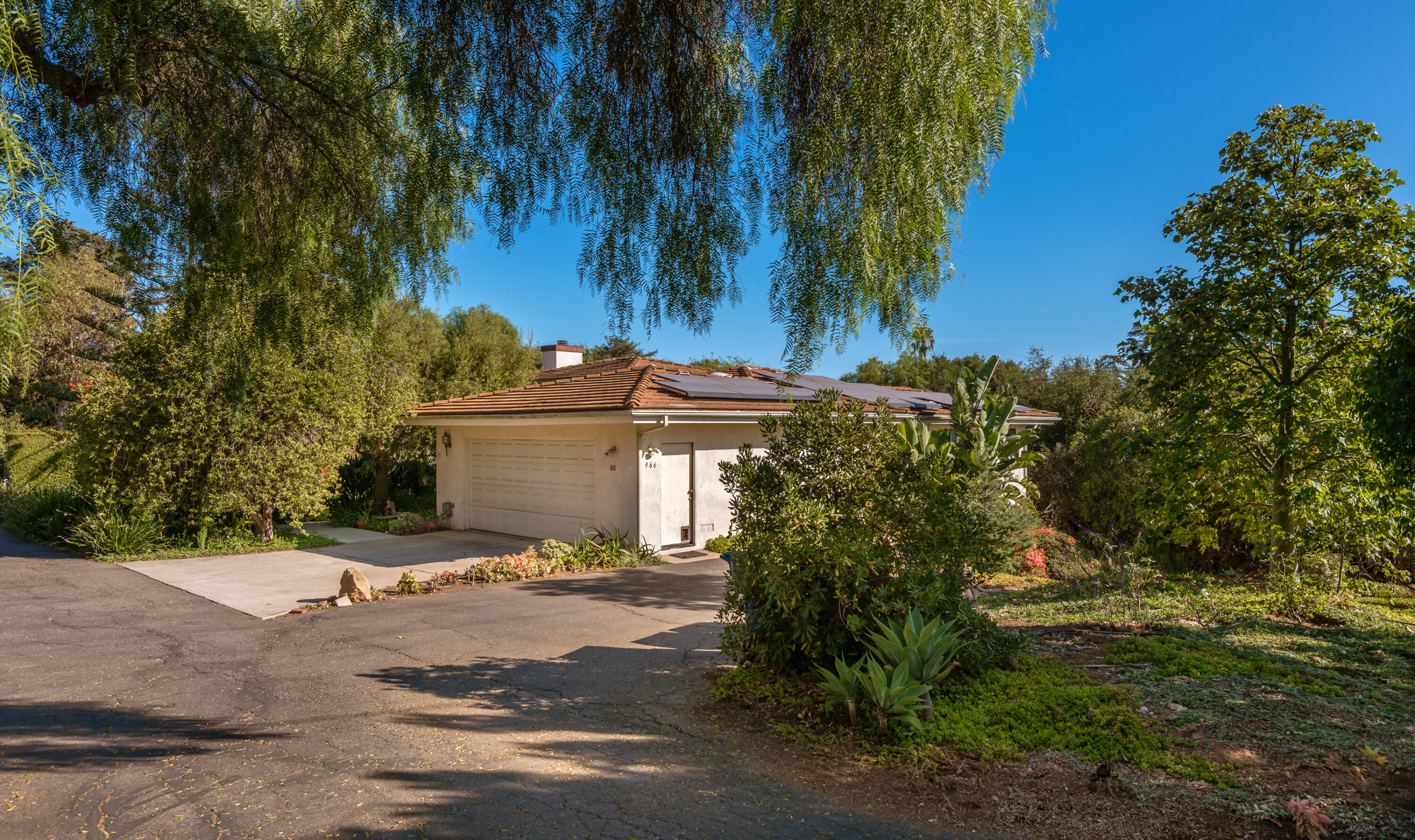 Undisclosed Address Santa Barbara, CA 93110 - Photo 3 of 12 a view of a white house with a big yard and large trees