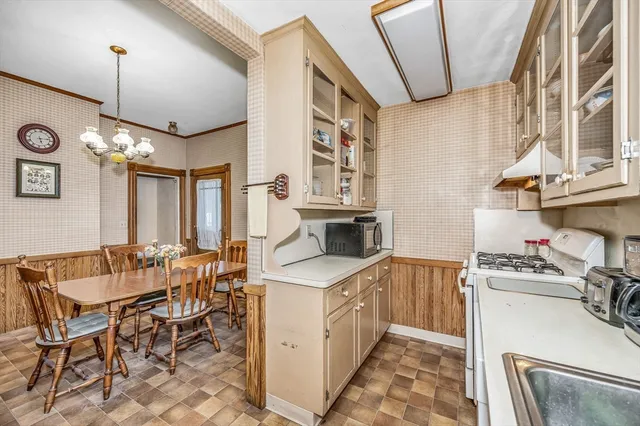 a kitchen that has a lot of cabinets in it and appliances