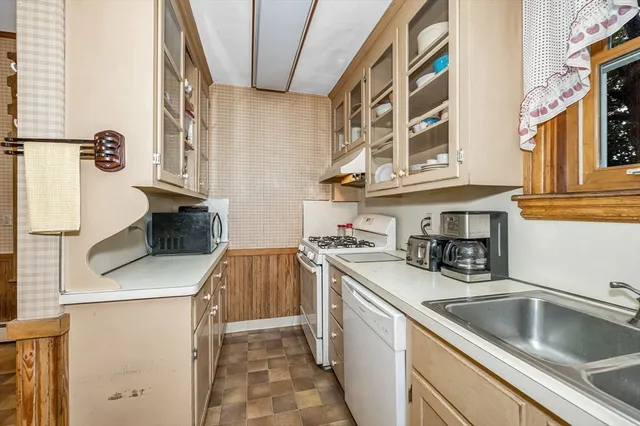 a kitchen that has a sink and a stove