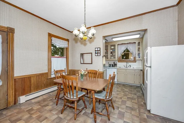 a dining room with furniture a chandelier and window