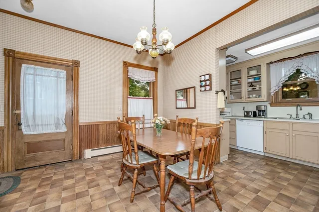 a view of a dining room with furniture and chandelier