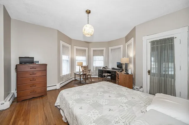 a bed room with a bed and a chair