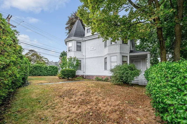 a view of backyard of house with green space