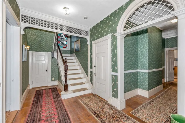 a view of entryway with stairs and wooden floor