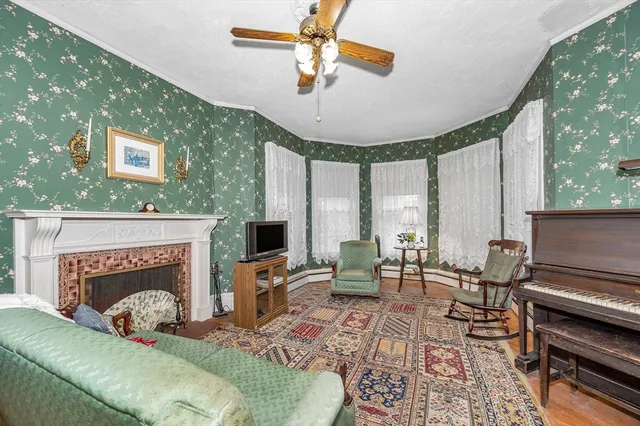 a living room with furniture fireplace and window