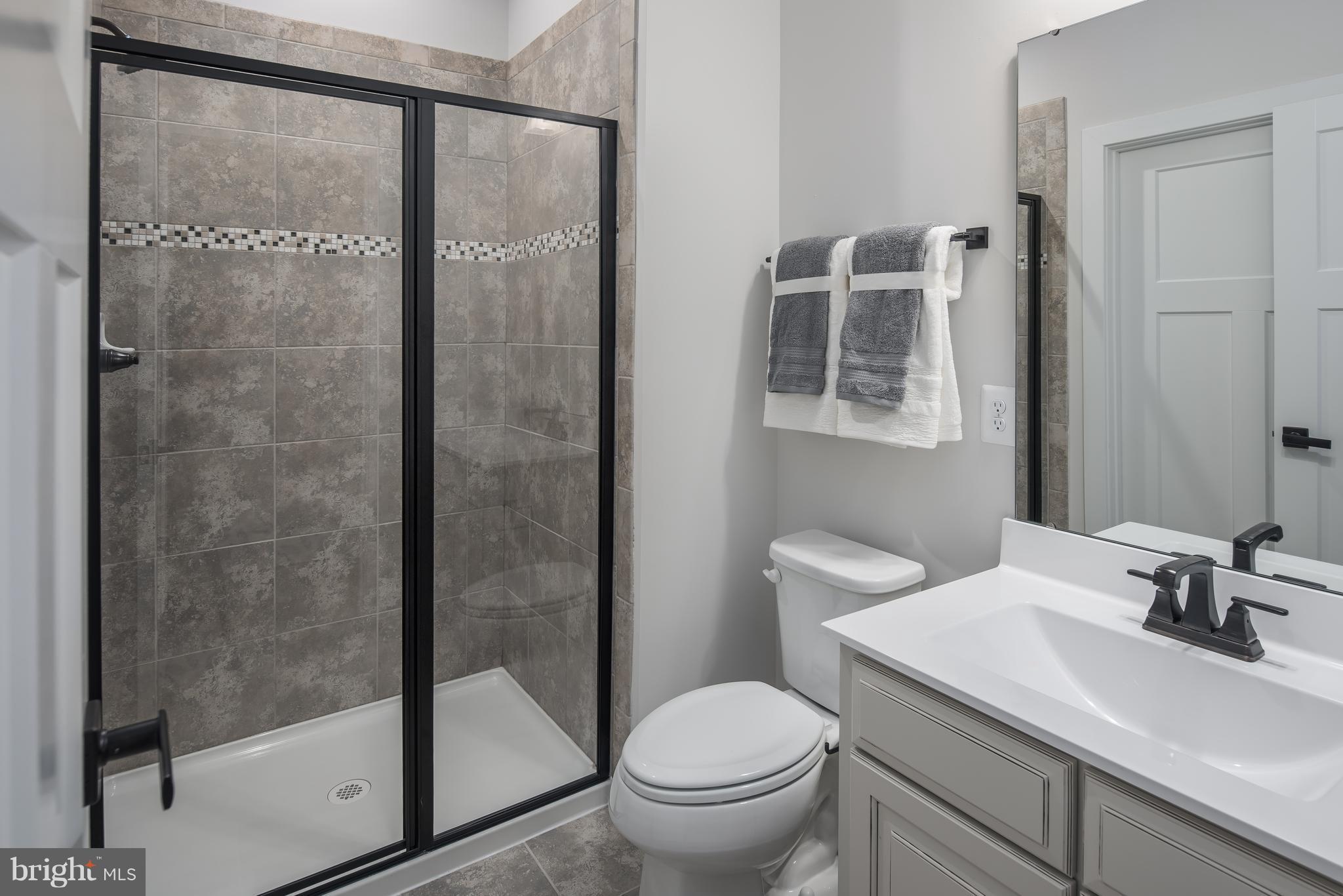 1258 Upper Patuxent Ridge Road Odenton, MD 21113 - Photo 11 of 23 a bathroom with a granite countertop sink toilet and shower