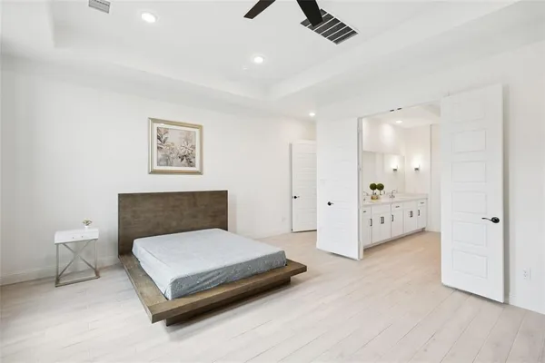 a bedroom with a bed and painting on the wall