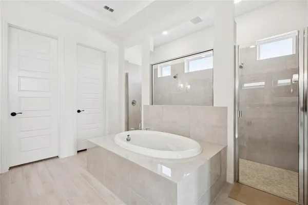 a bathroom with a tub and shower