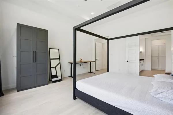 a bedroom with a bed and a dresser