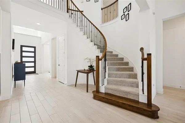 a view of entryway and hall with wooden floor