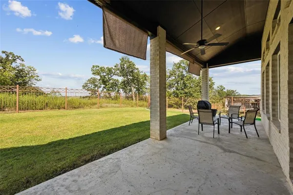 a view of a porch with furniture and yard