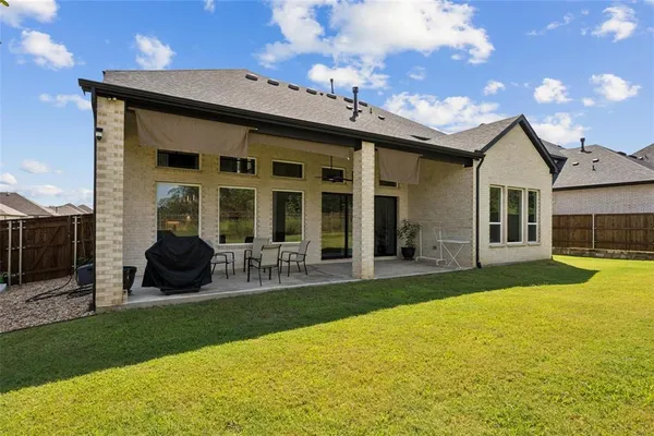 a view of a house with sitting area and garden