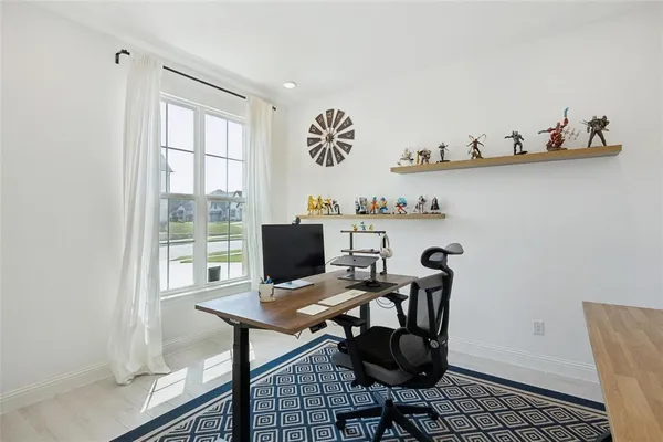 a view of a workspace with furniture and wooden floor