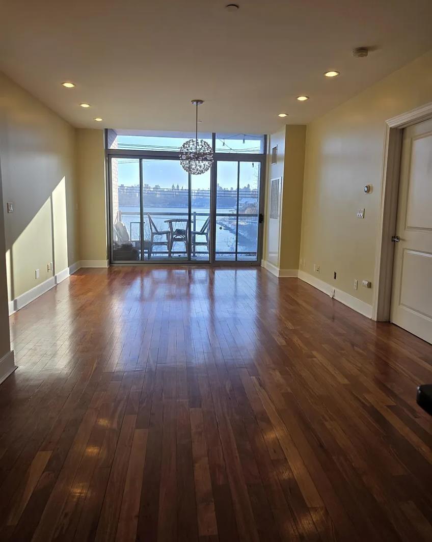 8125 River Road, Unit 3C North Bergen, NJ 07047 - Photo 11 of 23 a view of an empty room with wooden floor and a window