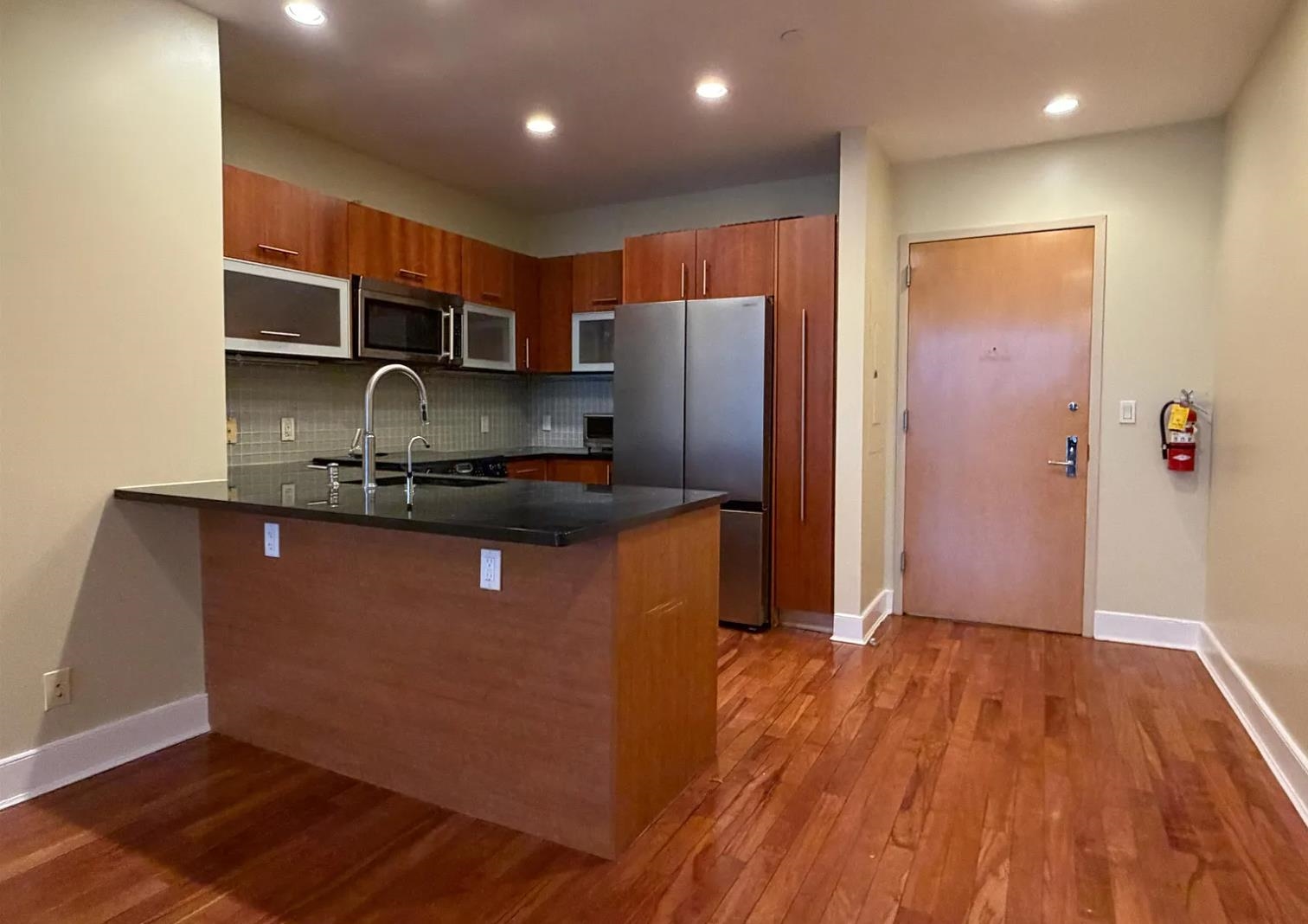 8125 River Road, Unit 3C North Bergen, NJ 07047 - Photo 2 of 23 a kitchen with stainless steel appliances granite countertop a refrigerator and a sink
