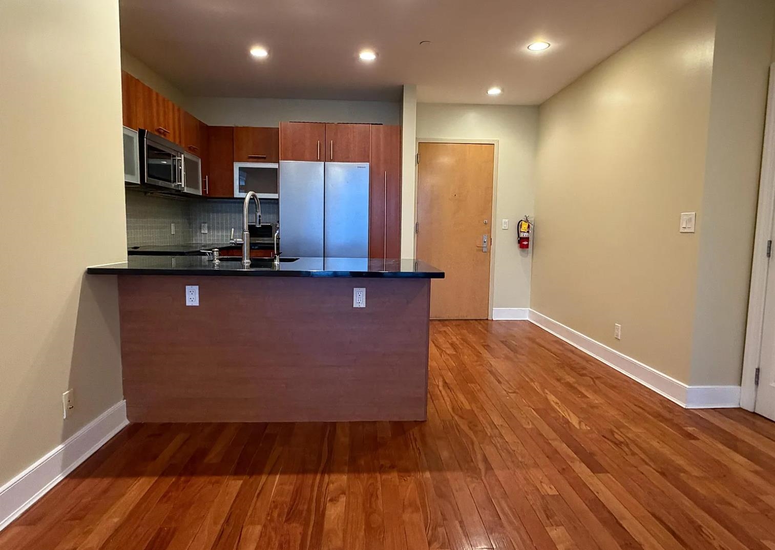 8125 River Road, Unit 3C North Bergen, NJ 07047 - Photo 3 of 23 a kitchen with stainless steel appliances granite countertop a sink a stove a refrigerator and cabinets
