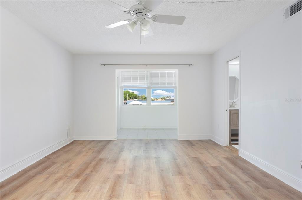 4725 Cove Circle, Unit 207 St. Petersburg, FL 33708 - Photo 16 of 46 wooden floor in an empty room with a window