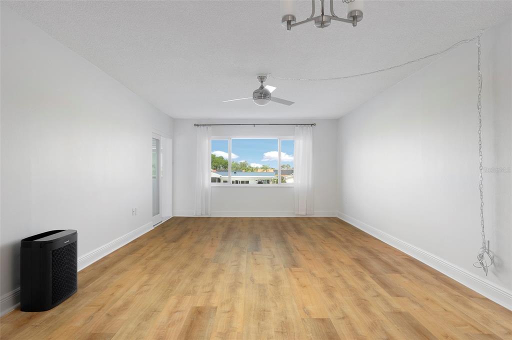 4725 Cove Circle, Unit 207 St. Petersburg, FL 33708 - Photo 2 of 46 an empty room with a fireplace and windows