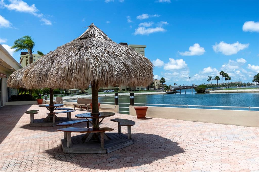 4725 Cove Circle, Unit 207 St. Petersburg, FL 33708 - Photo 22 of 46 a view of swimming pool with outdoor seating