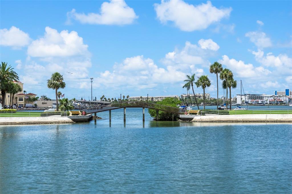 4725 Cove Circle, Unit 207 St. Petersburg, FL 33708 - Photo 23 of 46 a view of swimming pool with outdoor seating and yard in back