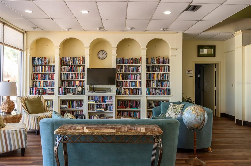 4725 Cove Circle, Unit 207 St. Petersburg, FL 33708 - Photo 26 of 46 a view of a living room with furniture and wooden floor