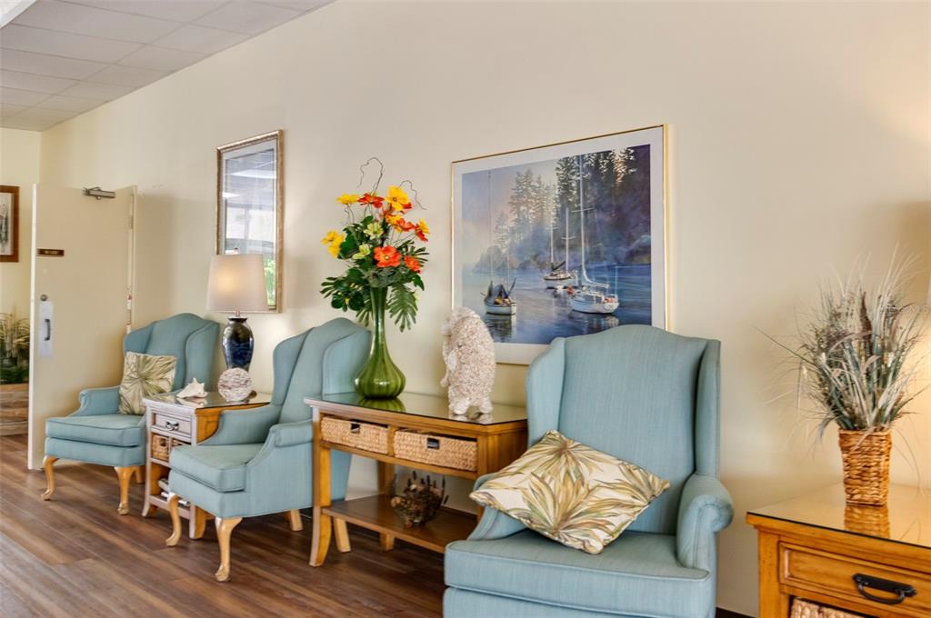 4725 Cove Circle, Unit 207 St. Petersburg, FL 33708 - Photo 27 of 46 a living room with furniture and wooden floor