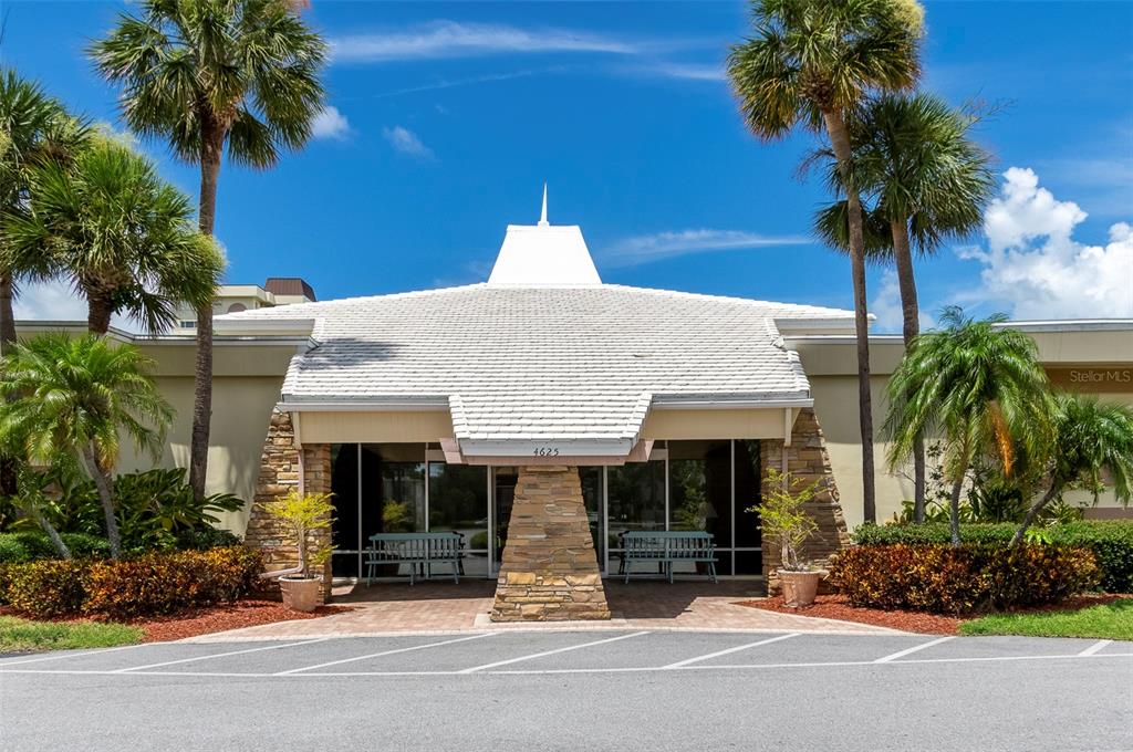 4725 Cove Circle, Unit 207 St. Petersburg, FL 33708 - Photo 28 of 46 a front view of a house with a garden