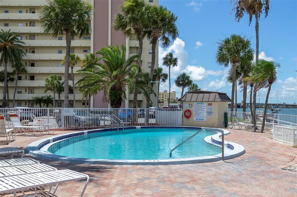 4725 Cove Circle, Unit 207 St. Petersburg, FL 33708 - Photo 32 of 46 a view of a swimming pool with a sitting area