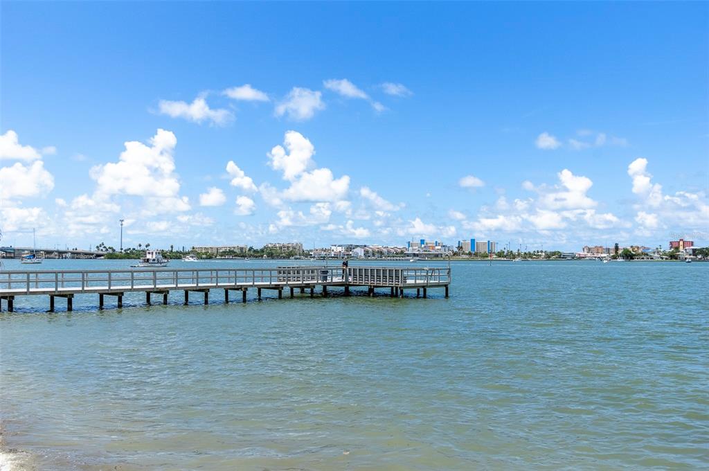 4725 Cove Circle, Unit 207 St. Petersburg, FL 33708 - Photo 37 of 46 a view of a lake with outdoor seating and city view