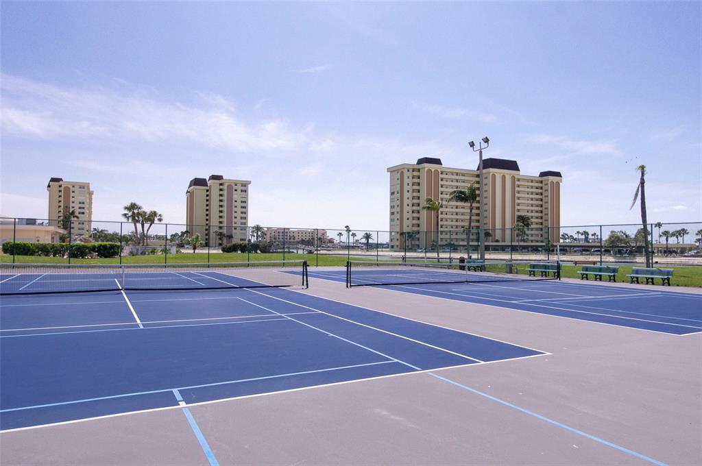 4725 Cove Circle, Unit 207 St. Petersburg, FL 33708 - Photo 38 of 46 a tennis court with view of tall buildings