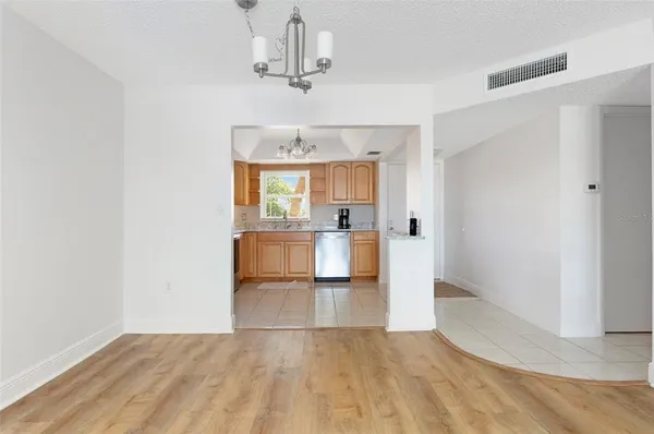 a view of a kitchen with furniture and wooden floor