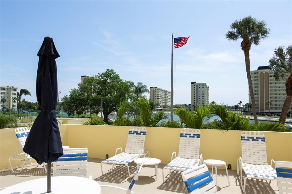 4725 Cove Circle, Unit 207 St. Petersburg, FL 33708 - Photo 43 of 46 a view of a terrace with couches and sky view