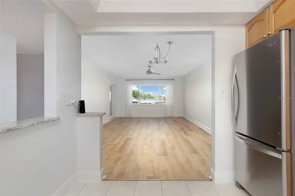a view of an empty room with a kitchen